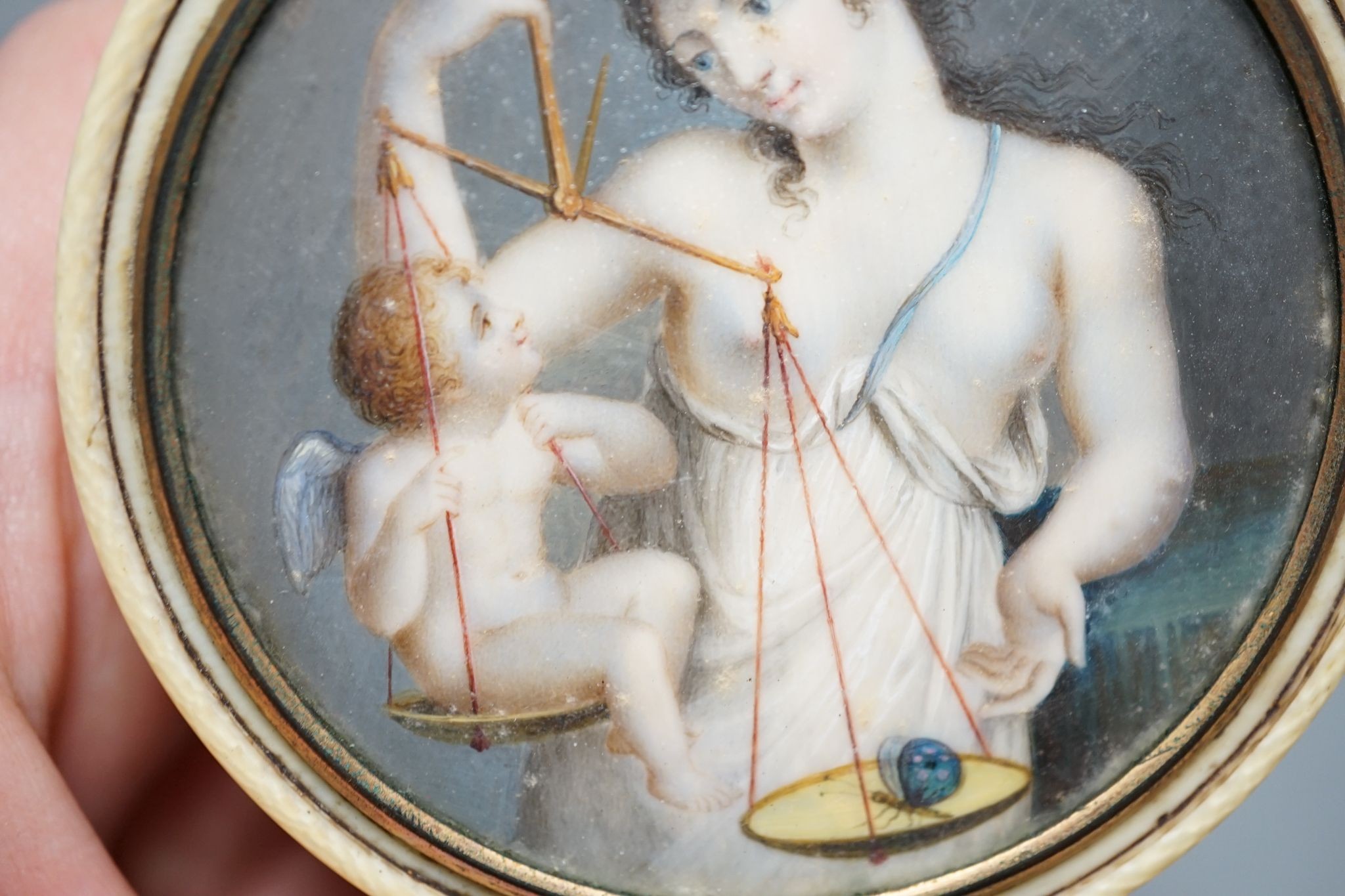 An early 19th century ivory and tortoishell box with inset miniature of Themis to cover, 8cm.